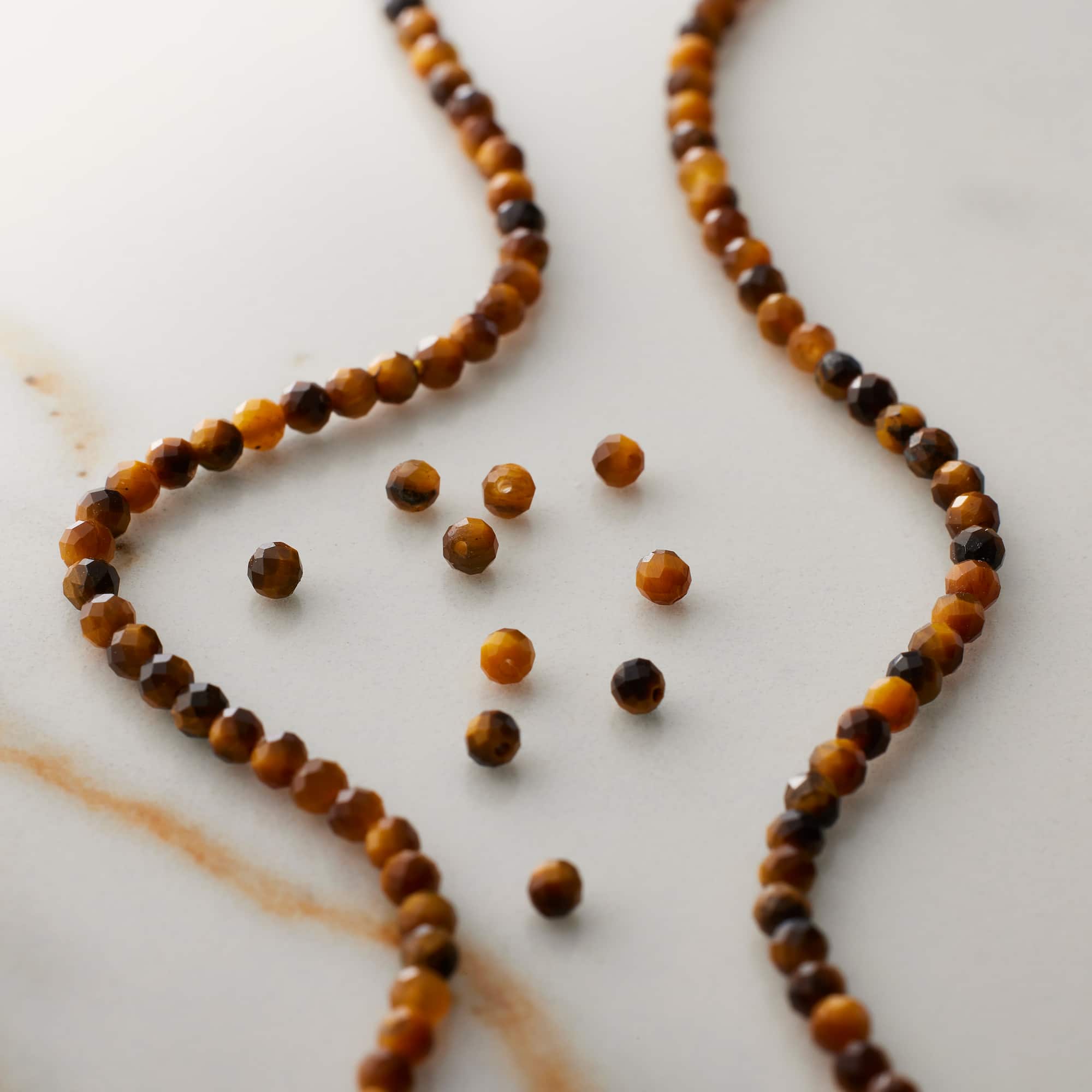 12 Pack: Tiger's Eye Faceted Round Beads, 2mm by Bead Landing™